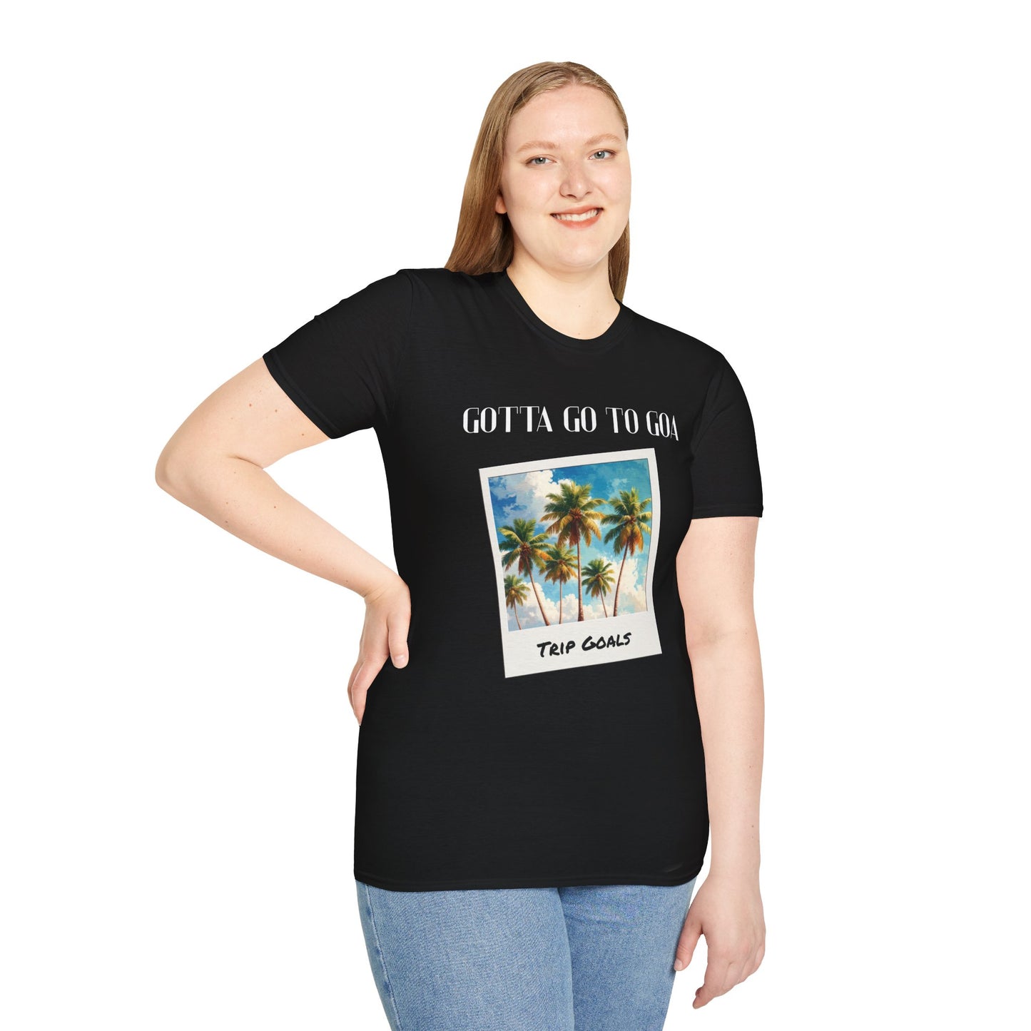a woman wearing a black shirt that says gotta go to goa with a graphic of goa beach as a postcard that says trip goals