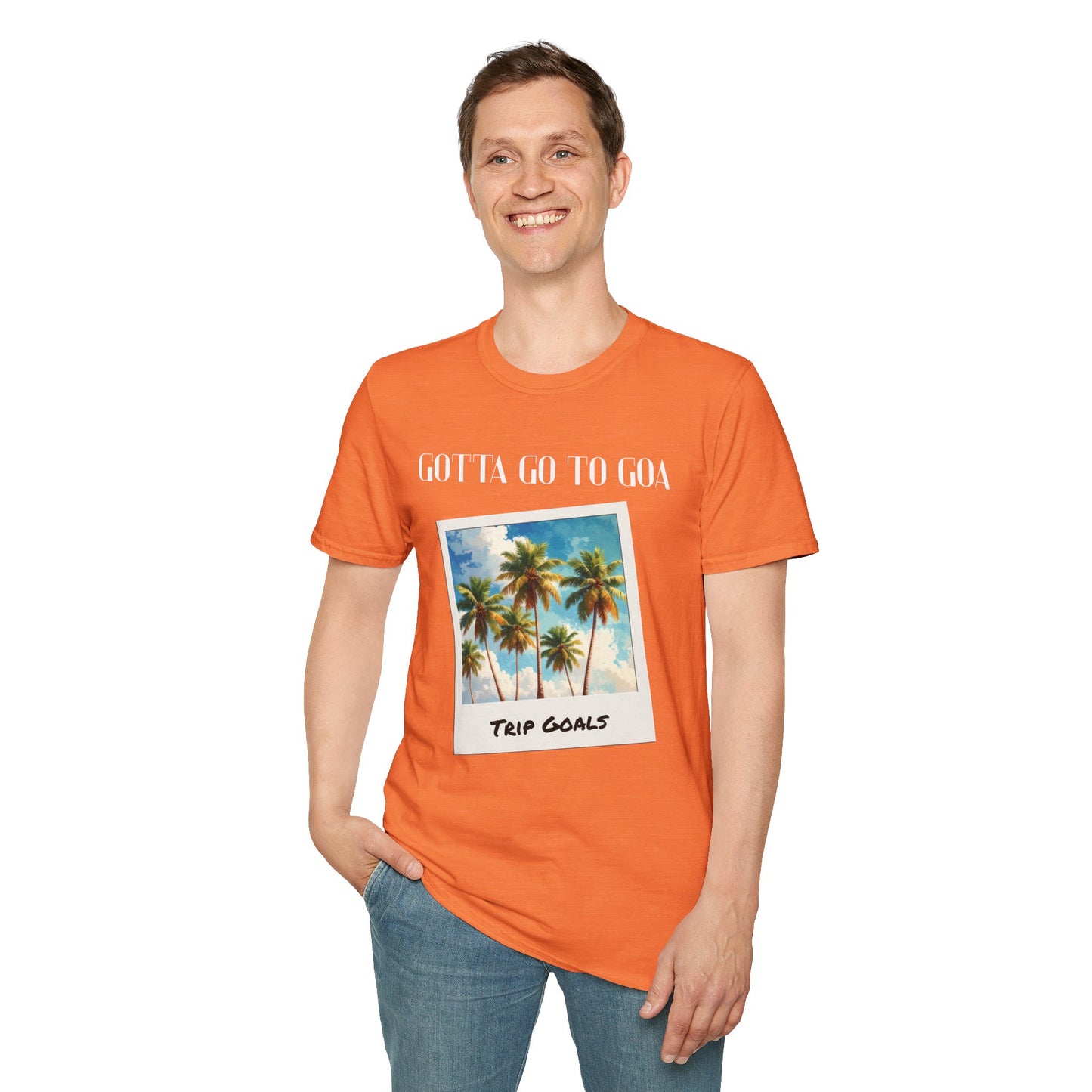 a man wearing a heather orange shirt that says gotta go to goa with a graphic of goa beach as a postcard that says trip goals