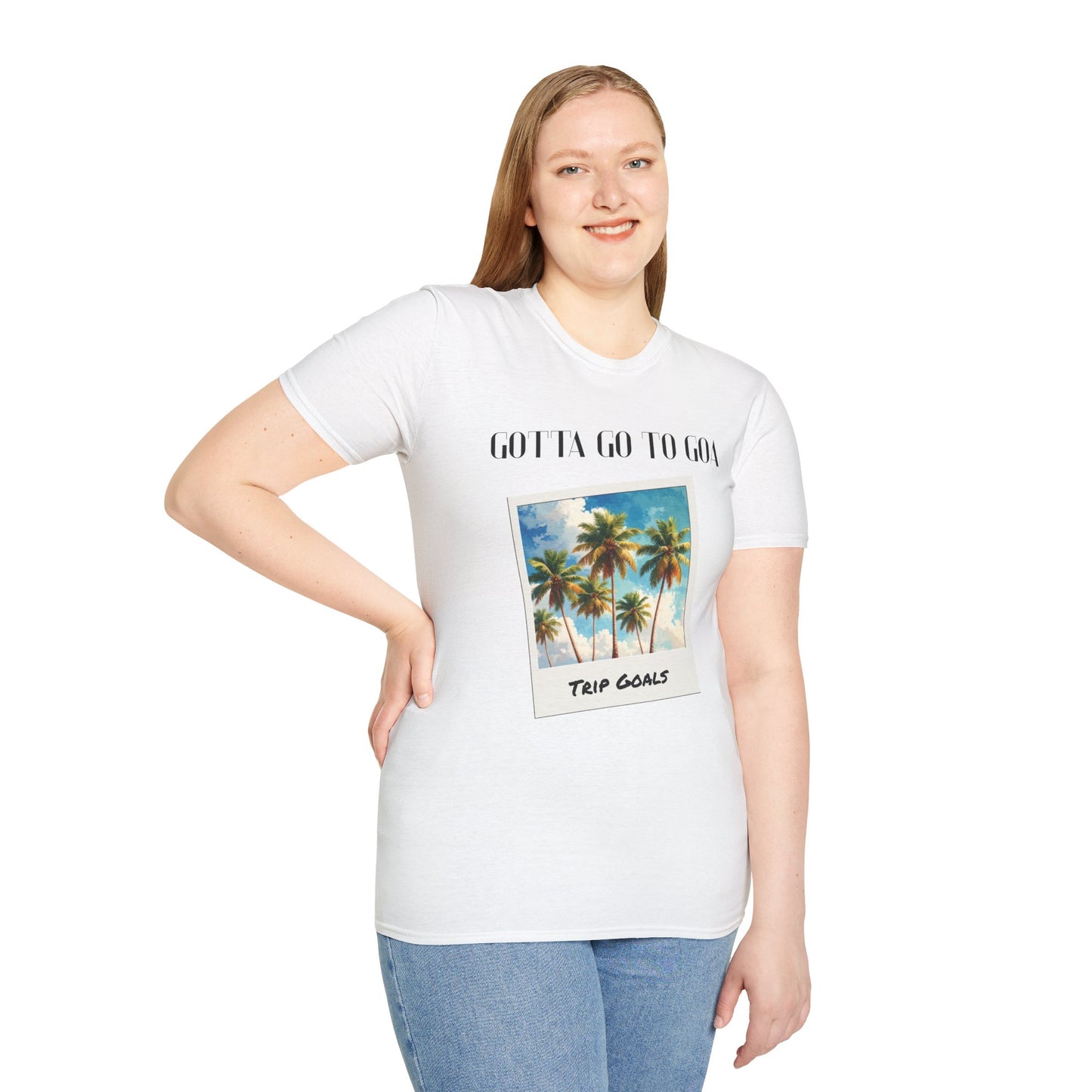 a woman wearing a white shirt that says gotta go to goa with a graphic of goa beach as a postcard that says trip goals