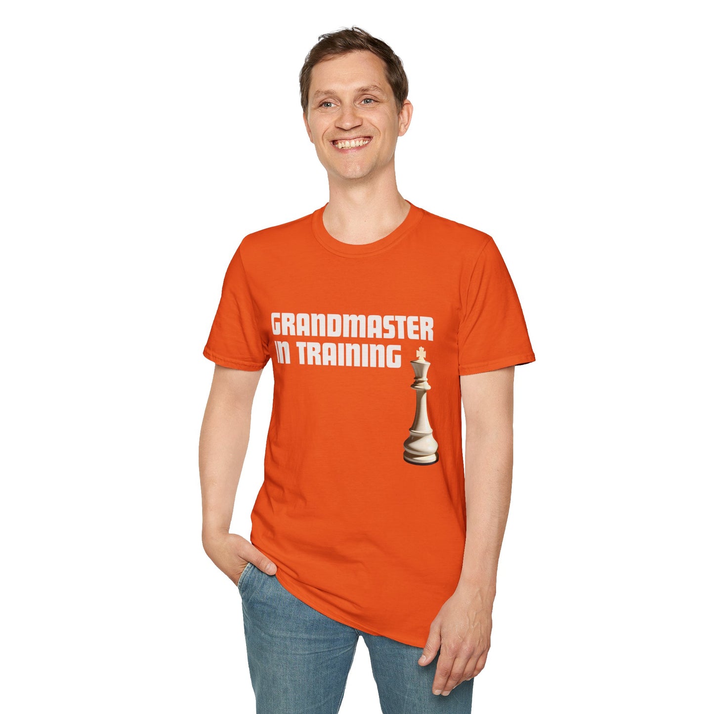 a man wearing a orange shirt that says Grandmaster in Training with a King chess piece