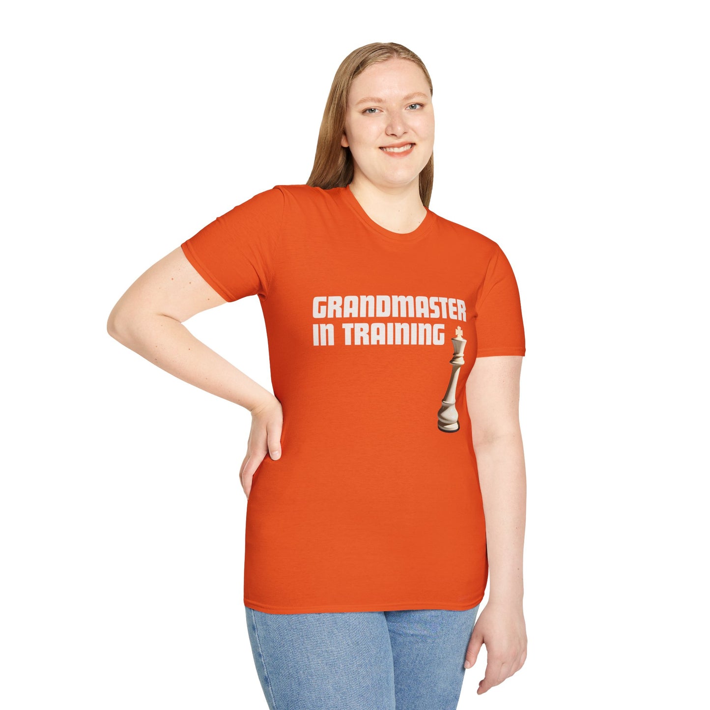 a woman wearing a orange shirt that says Grandmaster in Training with a King chess piece