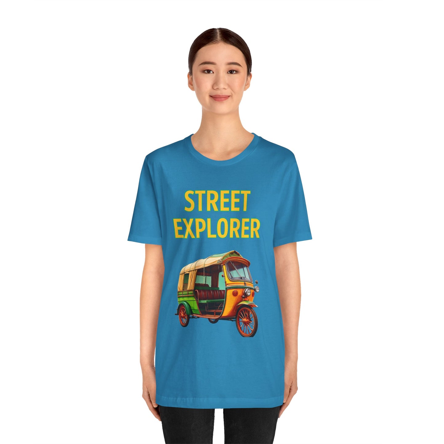 a woman wearing a aqua blue shirt that says street explorer with a graphic of an auto rickshaw