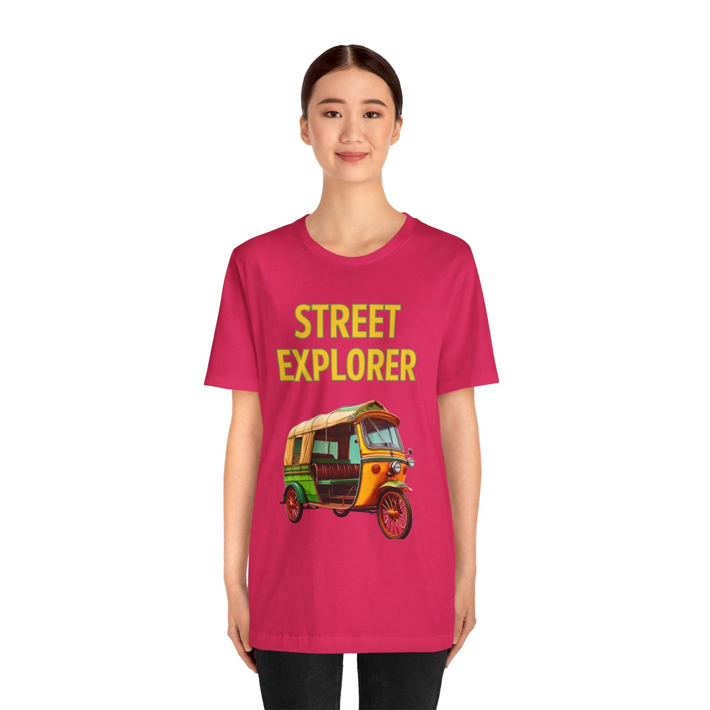 a woman wearing a fuchsia pink shirt that says street explorer with a graphic of an auto rickshaw