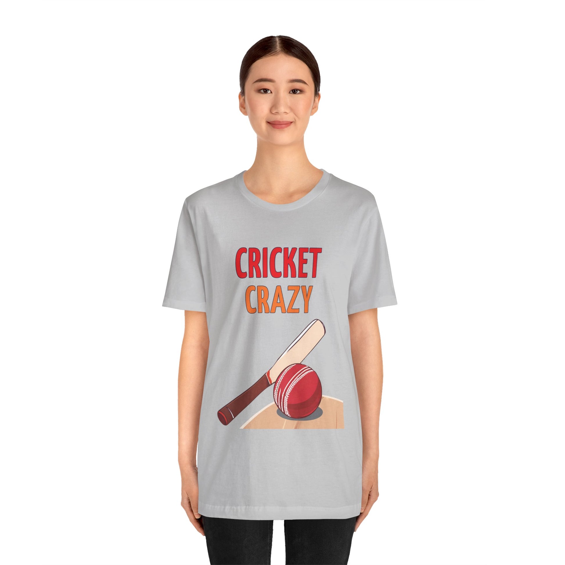 a woman wearing a solid athletic grey shirt that says cricket crazy with a graphic of a cricket bat and ball