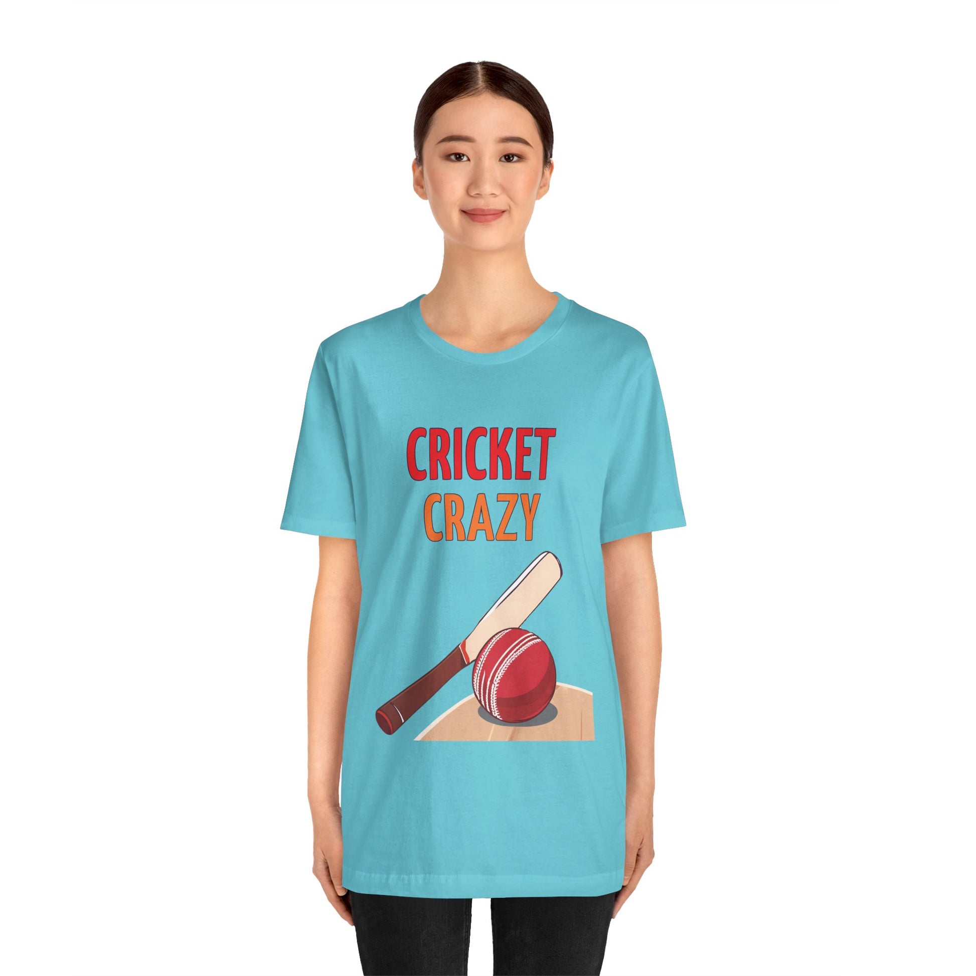 a woman wearing a turquoise blue shirt that says cricket crazy with a graphic of a cricket bat and ball