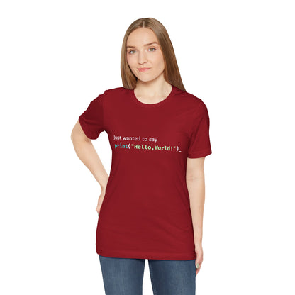 a woman wearing a canvas red shirt that says just wanted to say with hello world written in programming language