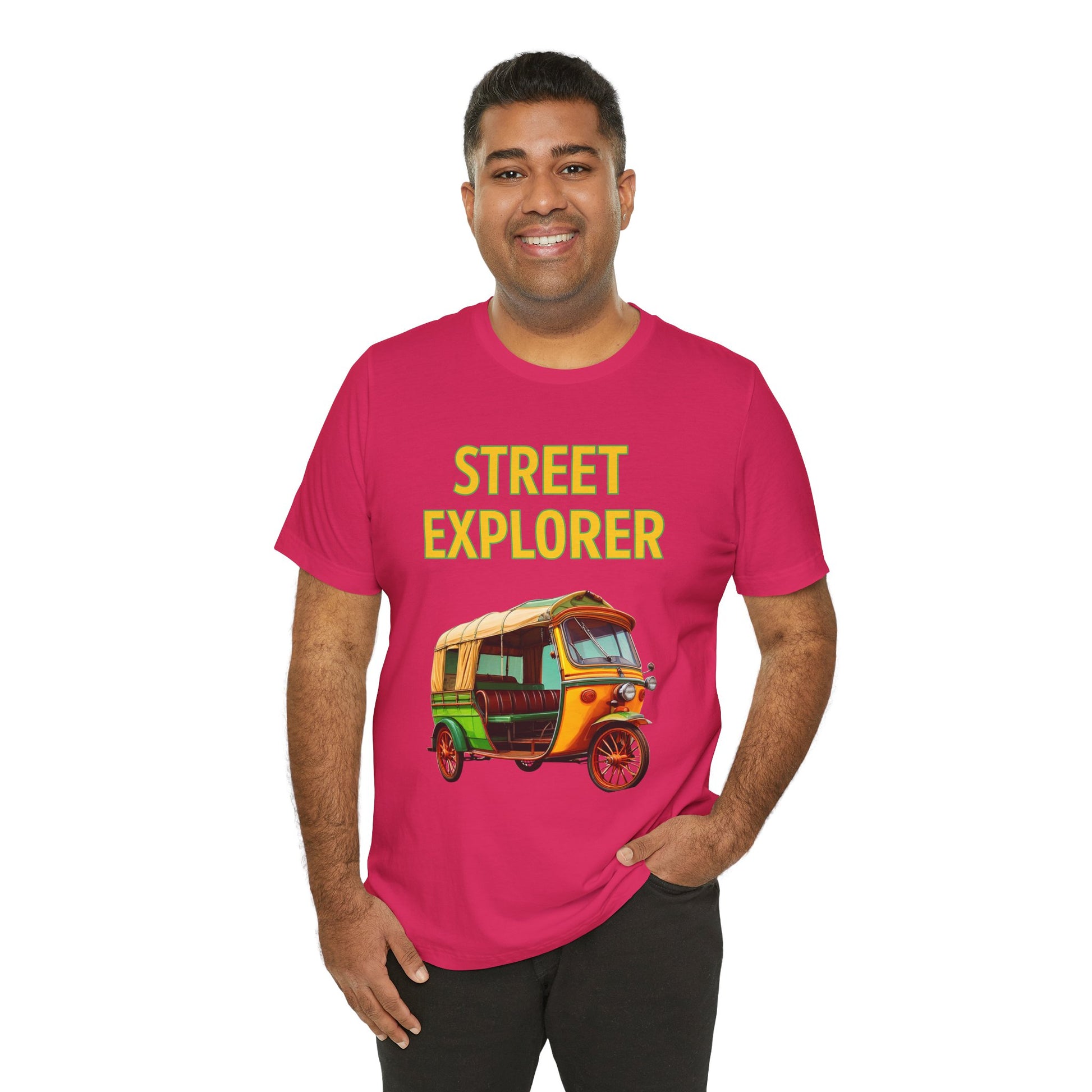 a man wearing a fuchsia pink shirt that says street explorer with a graphic of an auto rickshaw